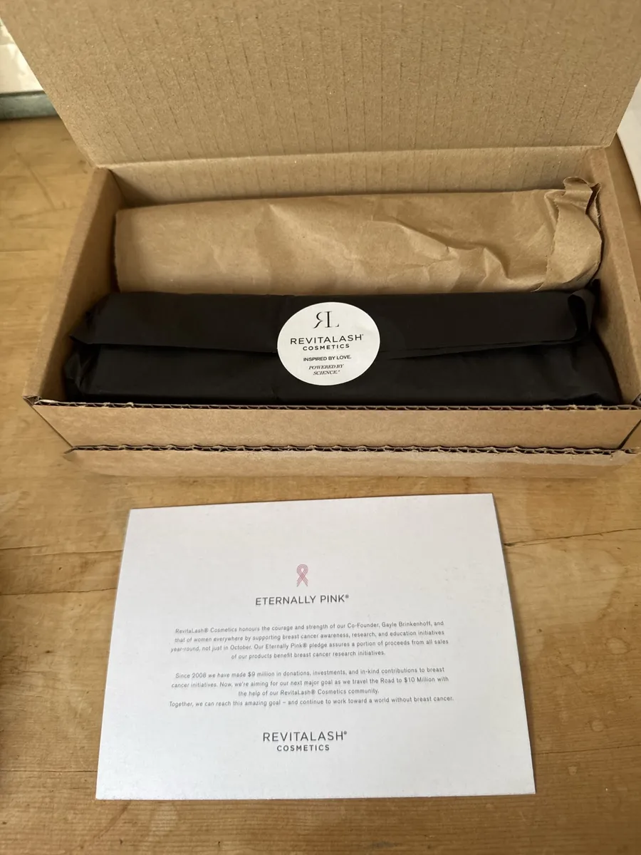 RevitaLash direct-order shipping box with tissue and sticker seal photographed by The Lash List